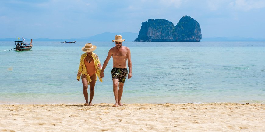 Par går på stranden på øen Koh Ngai i Thailand